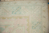 Soft, even wear on a vintage Oushak rug with its original side cord selvage intact.