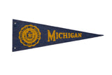 Vintage University of Michigan felt pennant, deep blue with yellow seal and 'Michigan' lettering.