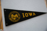 Close-up of vintage State University of Iowa felt pennant's gold seal and hanging holes.