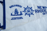 Blue felt binding on vintage pennant, with white felt surface showing subtle age patina.