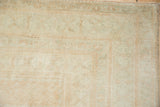 Soft, even pile and original side cord selvage of a distressed Oushak in sandalwood tones.