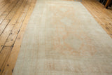 Full length perspective of a vintage Oushak carpet showing its soft lustrous pile.
