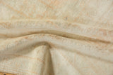 The lustrous texture of the distressed Oushak carpet's short, even wool pile.