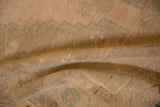 Soft, low pile and worn texture of a hand-knotted Oushak rug in sandy beige with hints of dusty turquoise.
