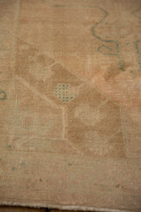Detailed texture of the distressed Oushak rug with mostly even wear showing the knot heads.