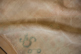 Back of the hand-knotted Oushak rug, showing the wool knots tied into the woven foundation.