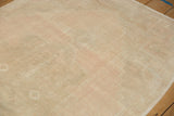 Close-up of the abrashed field with even wear in pale dusty rose and sand tones.