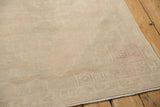Even wear reveals the faint, stepped corner pattern on this vintage distressed Oushak rug.