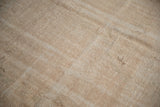 Hand-knotted distressed vintage Oushak carpet pile with worn texture and beige tones.