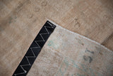 Vintage Oushak carpet reverse with a sewn black addendum belt and foundation.