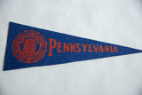 Orange university crest and text detail on a blue felt Pennsylvania University pennant.