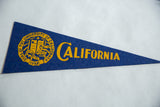 Blue felt University of California pennant with yellow school seal and text.