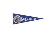 Vintage University of North Carolina blue felt flag with white school crest and text, circa 1950s.