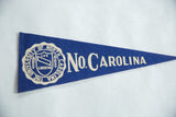 White school crest on a vintage blue felt University of North Carolina pennant.
