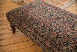 Detailed view of Persian Fereghan rug ottoman, featuring dense navy and terracotta antique pattern.