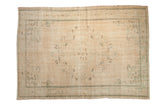 Vintage distressed Oushak carpet, oversized scalloped medallion, delicate vinery, soft ivory, mint green hues.