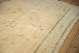 Subtle mint green and pale coffee brown motifs on a distressed vintage Oushak pile.