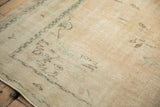 Distressed Oushak rug texture with worn ivory, cream, mint green pile and faint foundation.