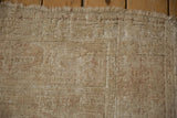 Exposed foundation and knot heads showcasing the distressed texture of a vintage Melas rug.