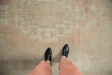Vintage distressed Oushak carpet with faded pale pink and sea foam green motifs.
