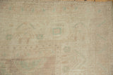 Distressed Oushak pile with even wear, showing faded ivory, pale pink, and sea foam.