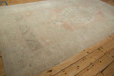 Distressed Oushak rug detail, showing even wear with faded pale pink and seafoam.