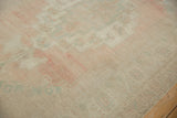 Even wear across knot heads on distressed Oushak carpet, featuring pale pink and sea foam abrash.