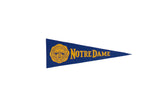 Vintage Notre Dame felt flag in blue and yellow with school crest. 3.25