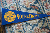 Gold lettering and university crest on the vintage Notre Dame felt flag.