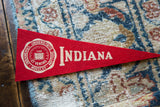 Detail of vintage Indiana University felt pennant, showing cream school crest and lettering.