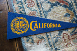 Blue felt texture of Vintage University of California flag with yellow crest.