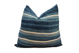Indigo African textile throw pillow with striped pattern and pieced construction.