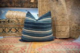Indigo African Textile Throw Pillow, close-up of visible stitched fabric strips.