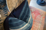 Navy linen blend backing and visible hand-stitching along the indigo striped textile.