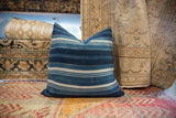 Vintage Indigo African textile pillow showing visible woven strips and varied blue stripes.