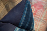 Textured seam of vintage African textile pillow, blending dark navy and indigo stripes.