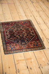 Angled view of a fine Farahan Sarouk rug, highlighting its traditional medallion and spandrel design.