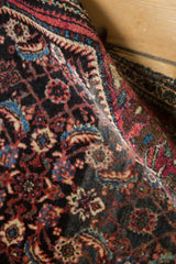 Rich texture and scrolling arabesques on a hand-knotted collector Farahan Sarouk rug.