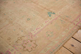 Low pile texture showing even wear to knot heads on a vintage distressed Oushak rug.