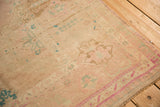 Hand-knotted texture and even wear of a distressed Oushak rug in soft pinks and aqua.