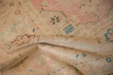 A soft fold on the distressed Oushak rug runner reveals its hand-knotted pile and texture.