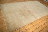 A long perspective view of the pale gold vintage Oushak's low, even pile.