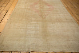 Soft, even wear and low-pile texture of a vintage distressed Oushak carpet.