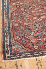 Overcast edge and boteh border detail on a hand-knotted Persian Malayer with even wear.