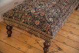 Vintage Persian Fereghan rug ottoman corner, displaying intricate floral motifs and ornate border.