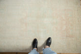 Low-pile texture and scale of a distressed vintage Oushak rug with faded, muted tones.