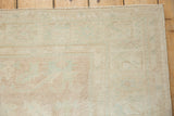 Close-up of a vintage Oushak rug's even wear down to the knot heads and its intact side selvage.