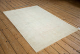 Vintage Turkish Oushak rug showing its evenly worn pile and intact side cord selvages.