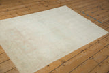 High-angle view of the entire vintage distressed Oushak rug, showing its soft muted pattern.