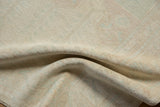 A soft fold in the vintage Oushak rug reveals its even wear and textural knot heads.